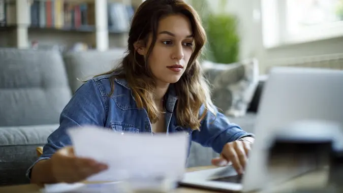 Woman paying her utility bills online stock photo