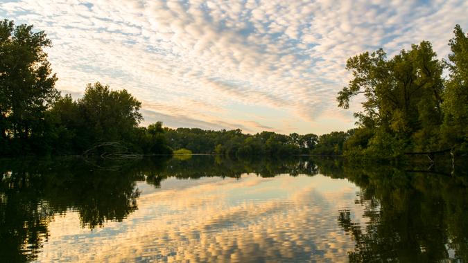 Sunset cloudscape with reflections off the smooth lake surface.