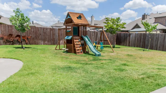 Outdoor play equipment in big backyard.