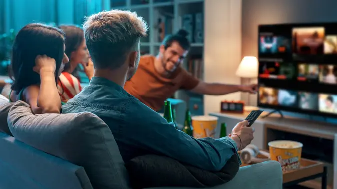 Friends watching movies together at home stock photo