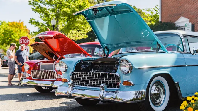 Matthews, North Carolina -  September 3, 2018: Visitors admire vintage 1950s era Chevrolet and Ford cars parked on display at the Matthews Auto Reunion.