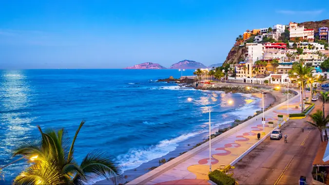 Stock photograph of beach and waterfront promenade in Mazatlan, Sinaloa, Mexico at twilight blue hour.