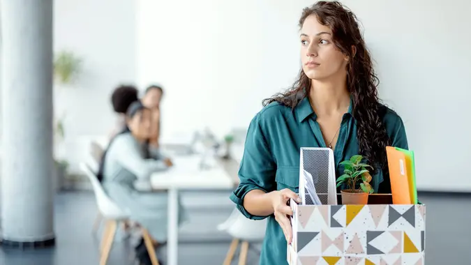 Portrait of young beautiful woman employee getting fired from work.