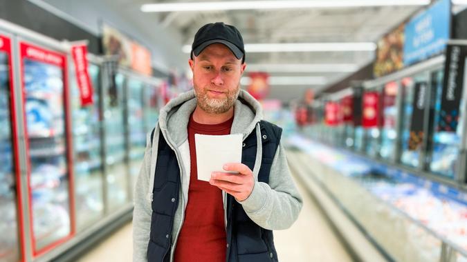 Color image depicting a mid adult male in the supermarket.