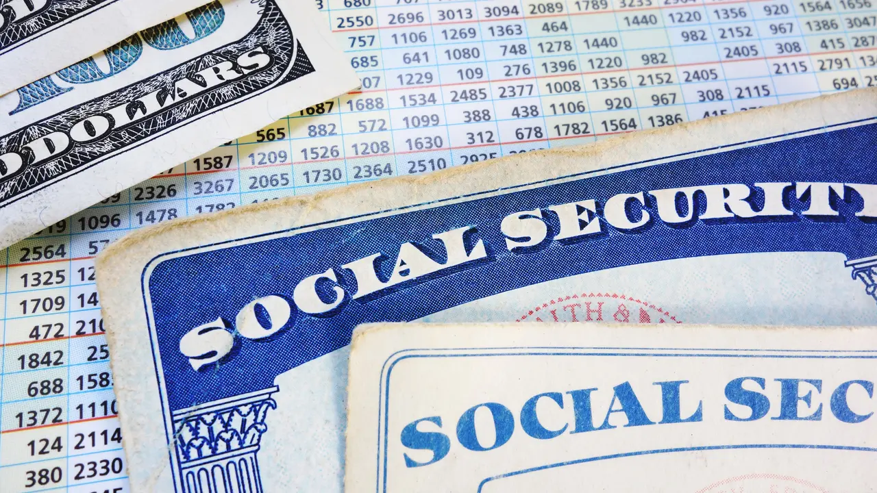 Social Security cards with cash and benefit amount numbers.
