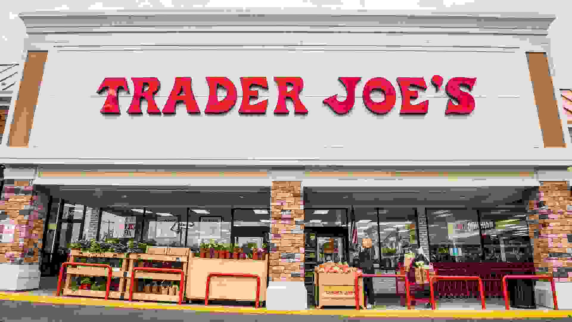 Fairfax, USA - November 25, 2016: Trader Joes grocery store facade with sign and items on display and people walking.