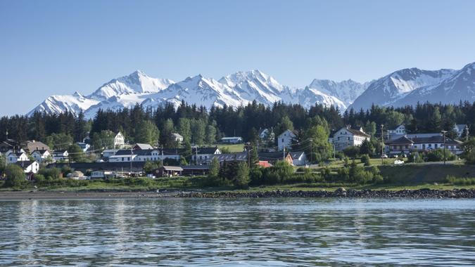 Haines Alaska from across the water with snow on the mountains.