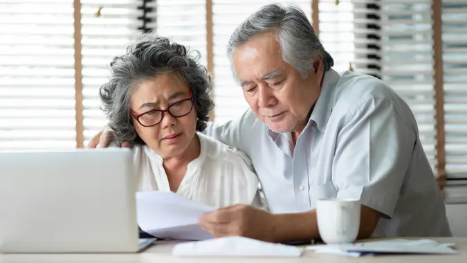 Senior Couple calculate their monthly expense. stock photo
