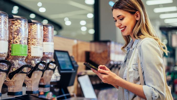 Young woman at grocery store stock photo