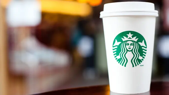 Grande Starbucks to go cup on table stock photo