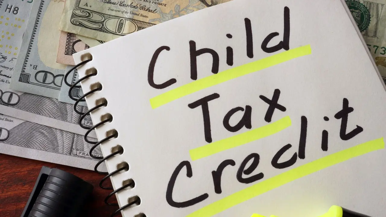 Notebook with  child tax credit sign on a table.