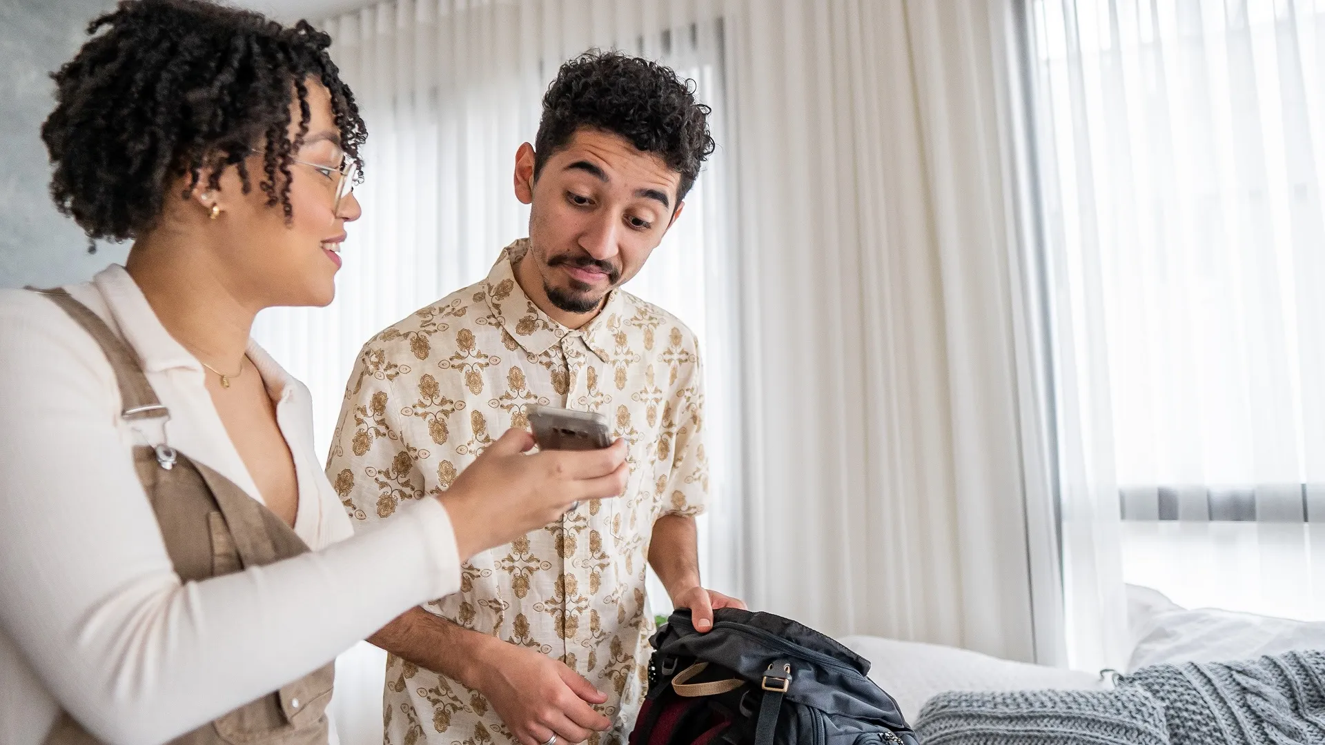 Couple checking reservation on smartphone stock photo