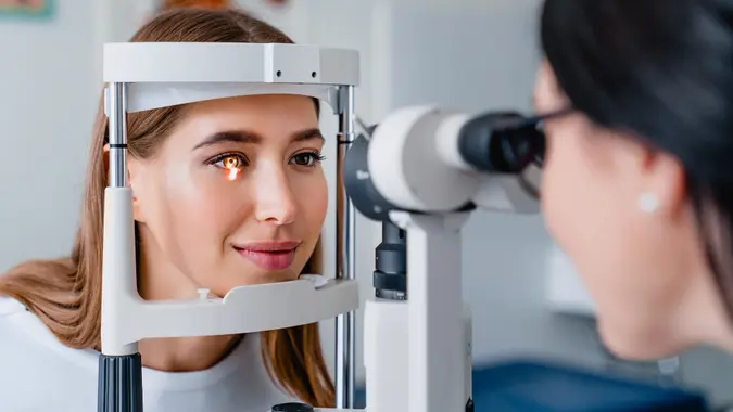 Eye doctor with female patient during an examination in modern clinic stock photo