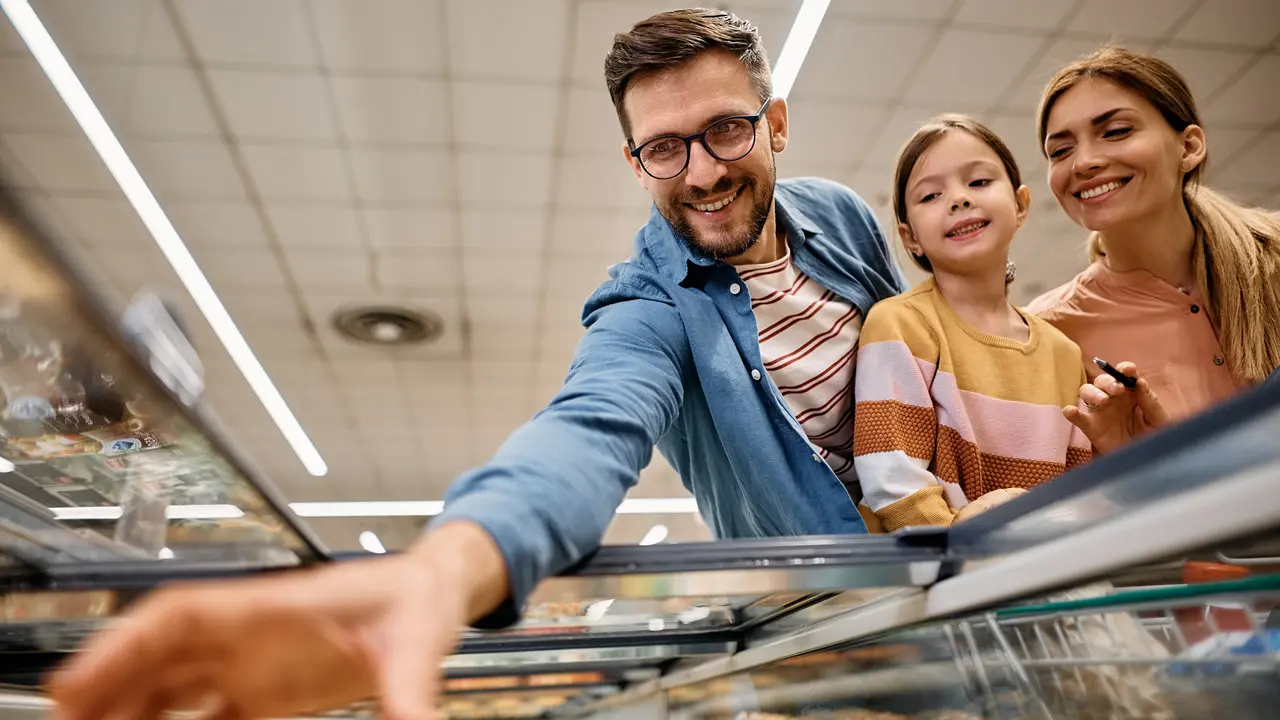 Below view of happy family shopping in supermarket. stock photo
