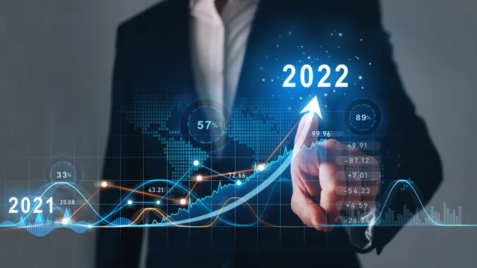 Businessman draws increase arrow graph corporate future growth year 2021 to 2022.