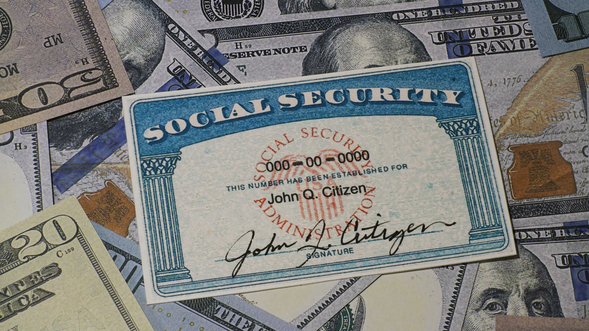 Lake Elsinore, CA, USA - January 30, 2022: Fake Social security card on prop US currency - Concept of Social Security Benefits.