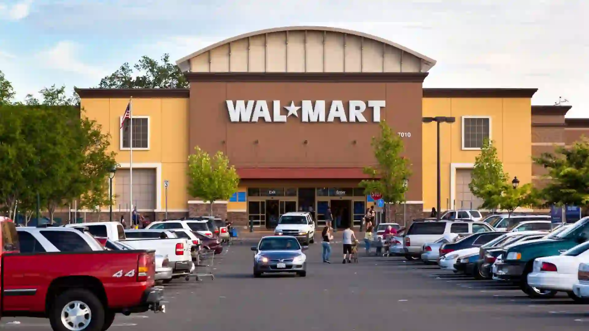 View of a Walmart storefront from its parking lot.