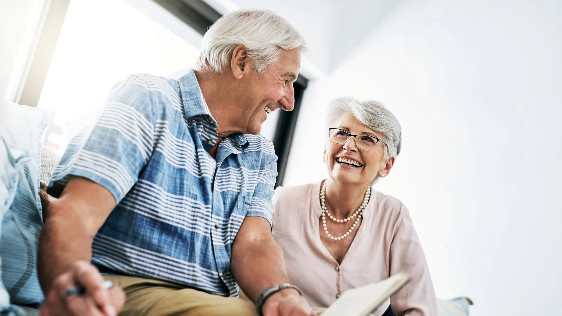 Shot of a senior couple going through their paperwork together at home.