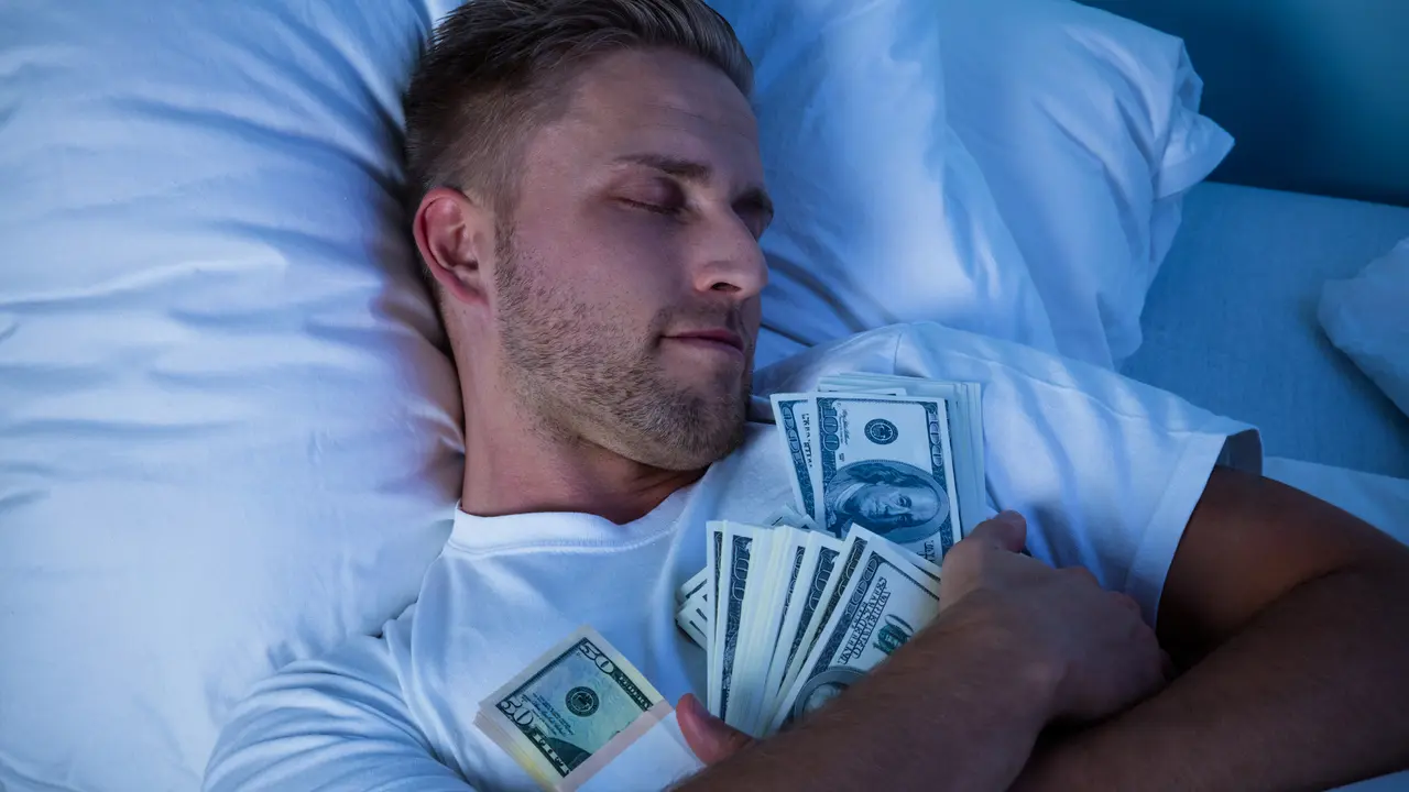Man Sleeping On Bed With Bundle Of Currency Notes.