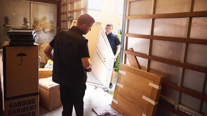 Loading furniture into moving truck stock photo