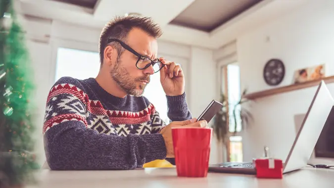 Man using smart phone at home stock photo
