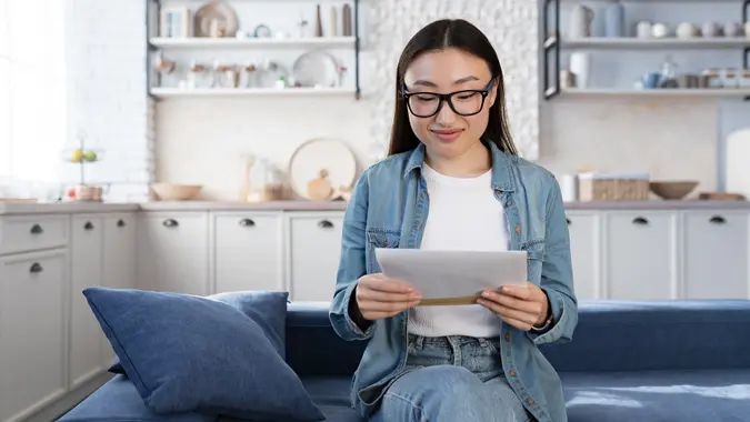 Young beautiful asian female student received happy letter from university stock photo