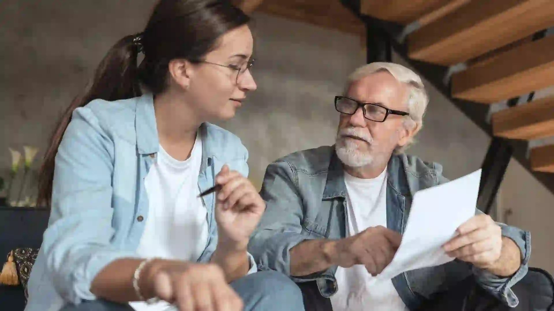 Social worker visits adult single man and helps him with online payments. stock photo