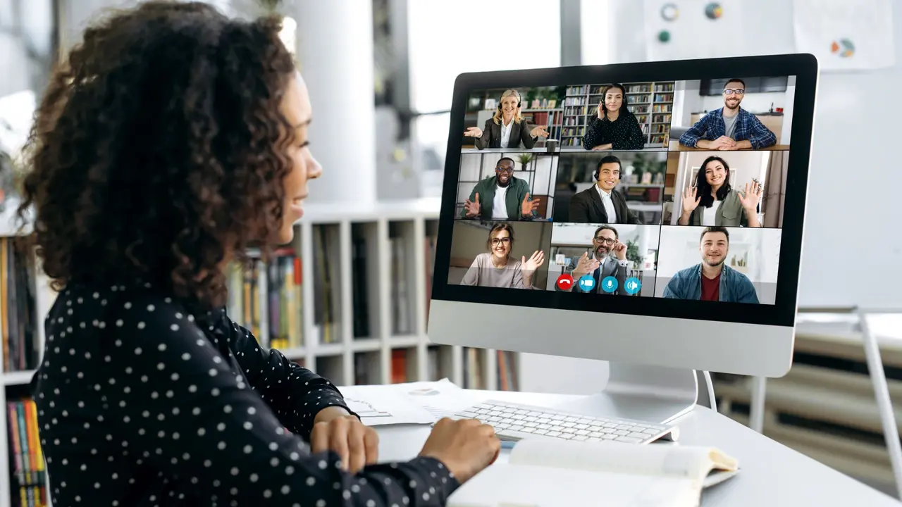 African american business woman, sits in front of a computer screen, talks via video link with international colleagues, employees, discusses a future project, perspective, business strategy, plan.