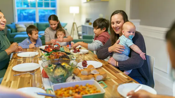 Family eating together at holiday table stock photo