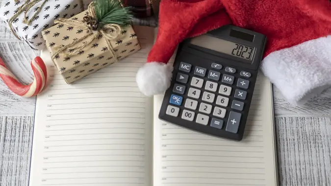 New Year's layout with calculator, Santa's hat and Christmas decorations stock photo