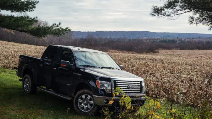 "Aspen, Canada - November 2, 2012: A late model Ford F-150 parked near a field of harvested corn in Nova Scotia's Guysborough County.
