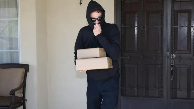 Porch Pirate Steals Packages Horizontal stock photo