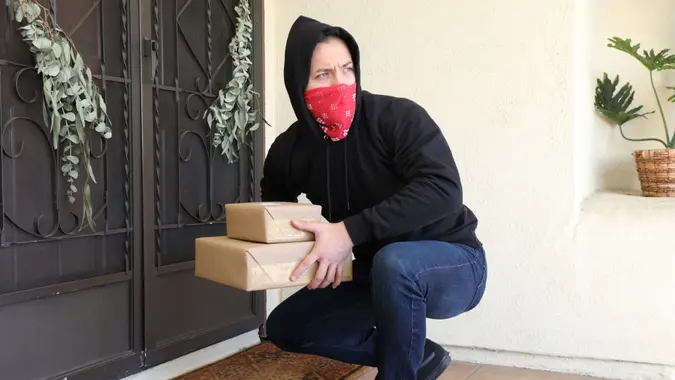 Man steals packages off porch.