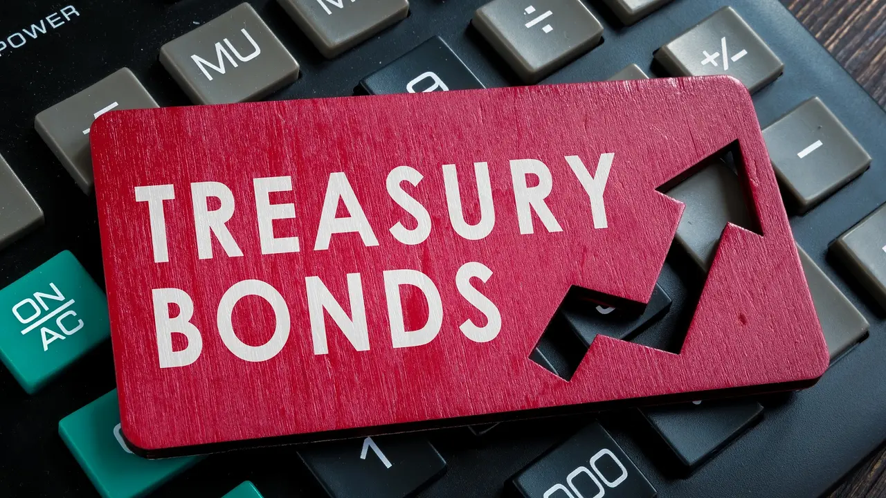 Treasury bonds words on the red plate and calculator. stock photo