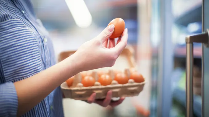 Woman buying food at grocery store. stock photo