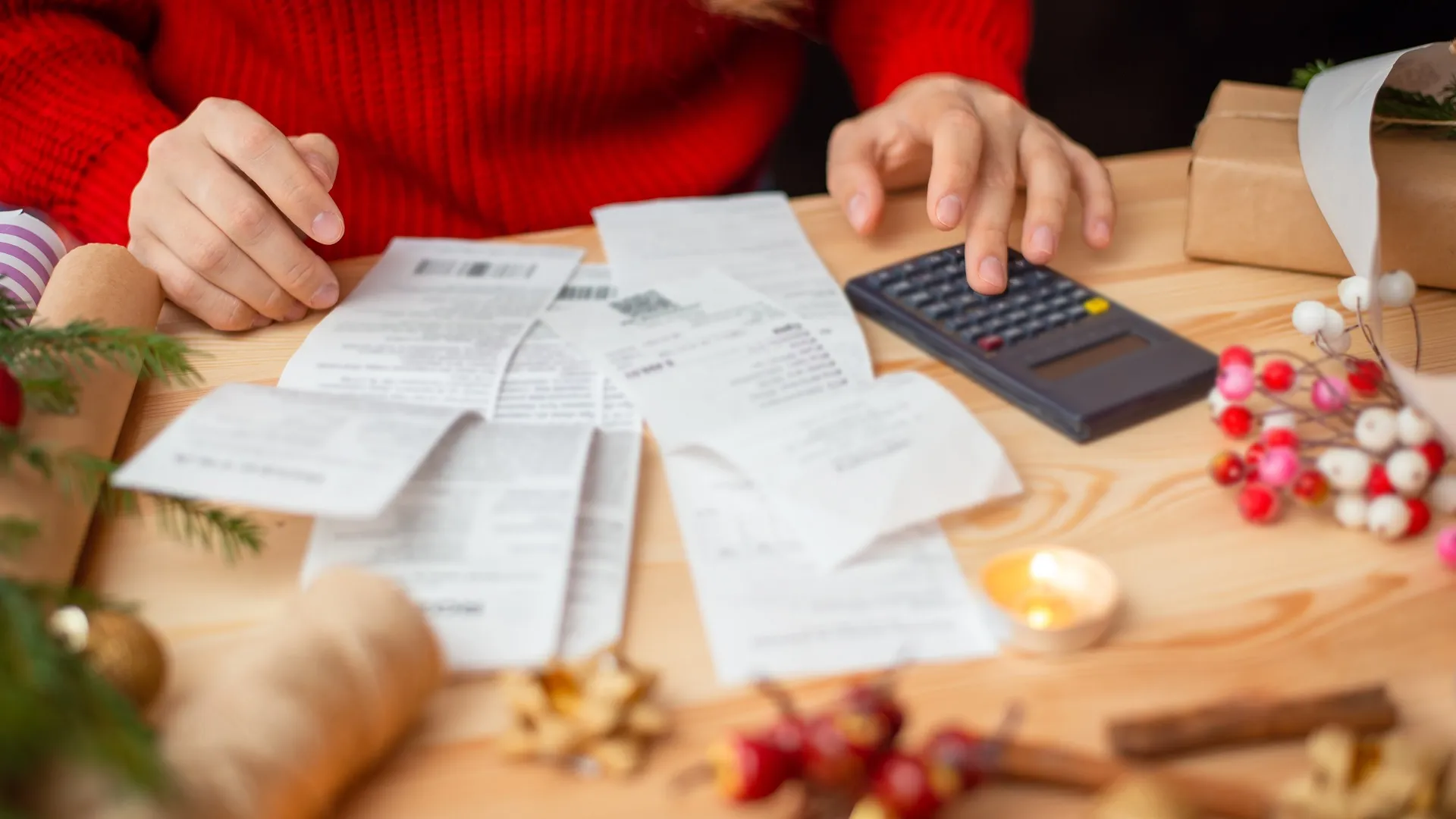 Close-up shot of checks, bills and receipts on wooden table and girl counting them stock photo
