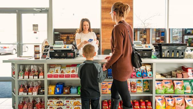 Mother with son shopping in a delicatessen store stock photo