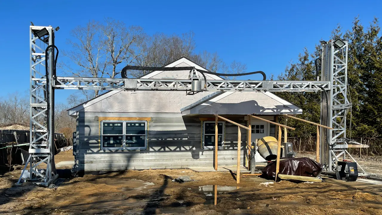 the front of a 3D printed house under construction, that will be for sale to the general public.