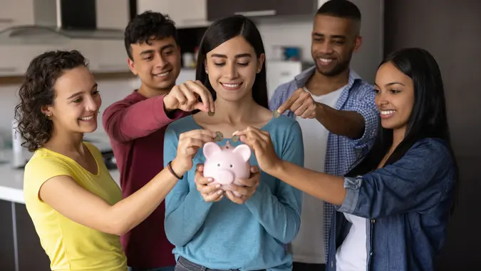 Group of flat mates making a collection for their home budget stock photo