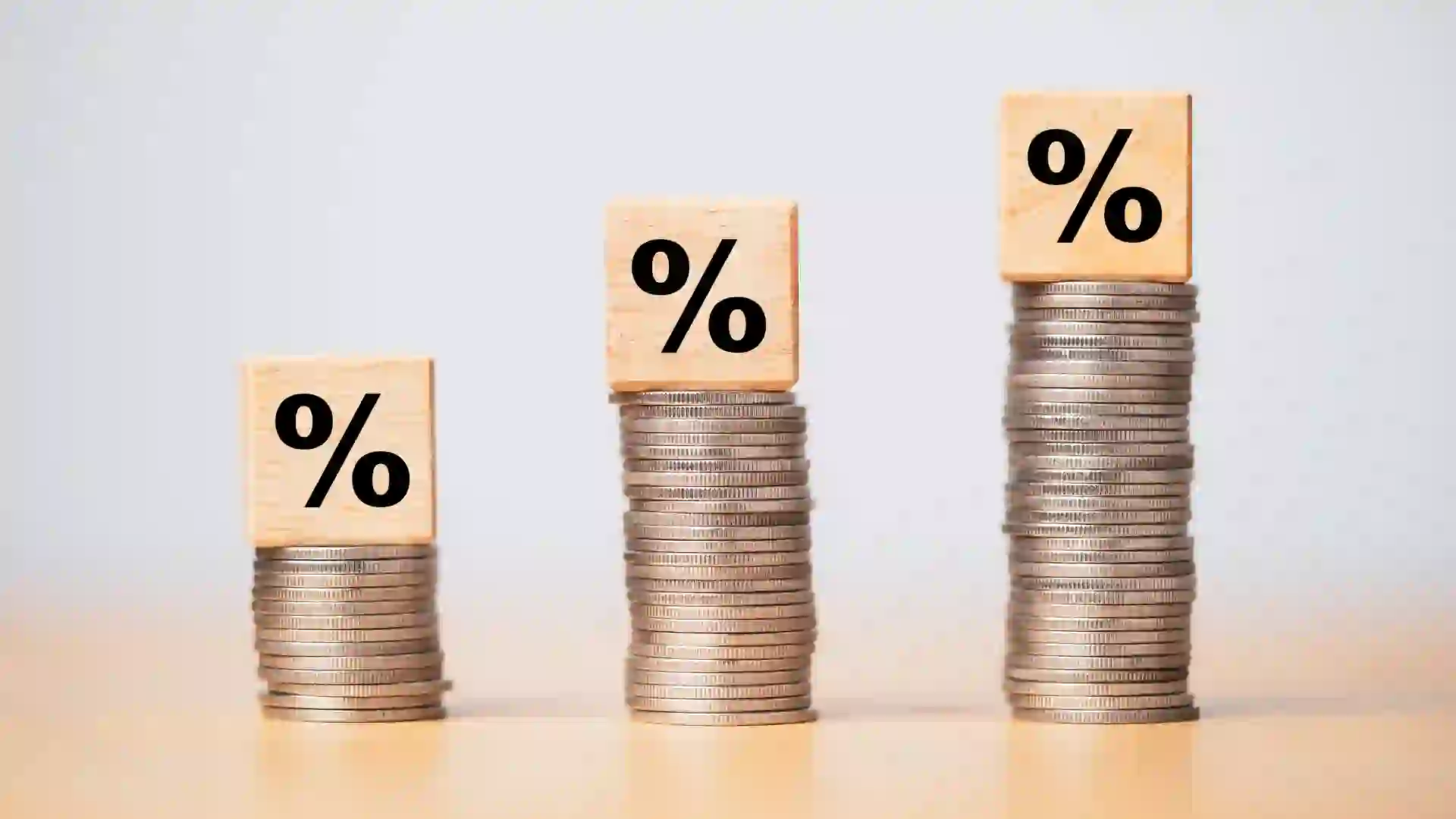 Percentage sign print screen on wooden cube block which lay down on increasing coins stacking for interest rate