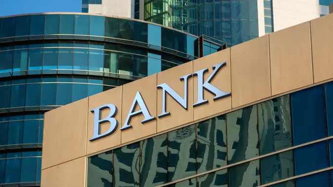 Bank sign on glass wall of business center.