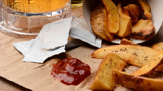 French Fries spilled onto a brown bag.