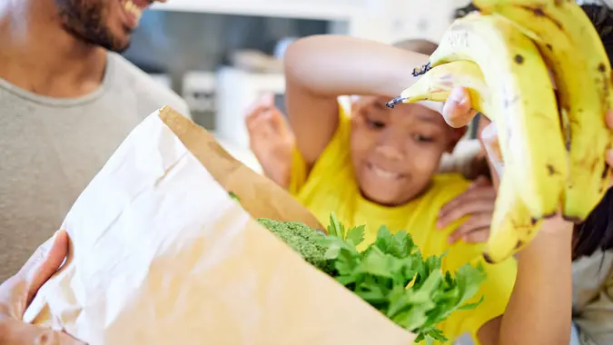 Shot of a family unpacking the groceries in the kitchen at home stock photo