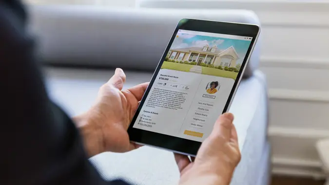 Unrecognizable person looks for home using mobile app stock photo
