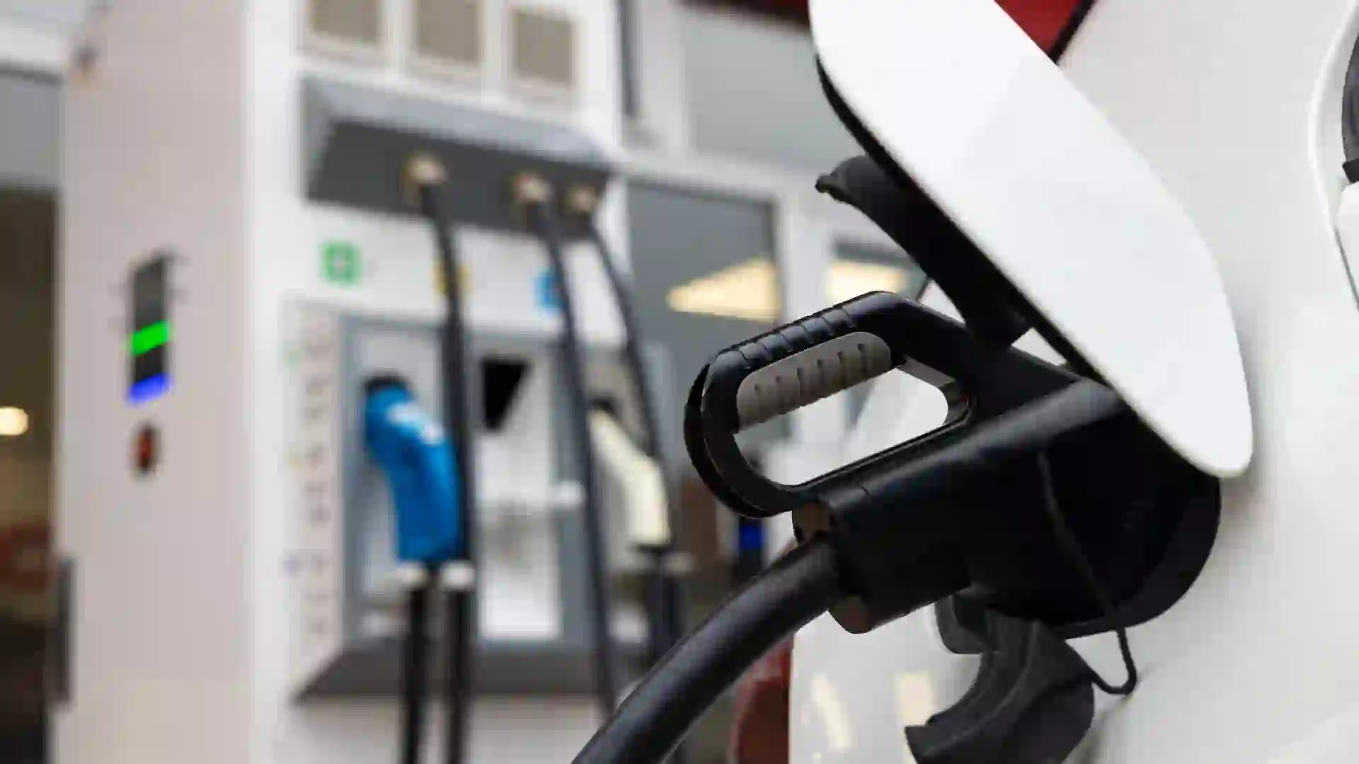 Close up of an electric car charging at the electric vehicle charging station.