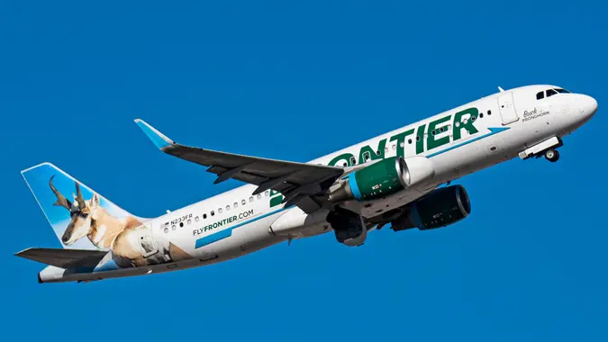 Phoenix, United States – December 24, 2022: A Frontier Airlines A320 N233FR airplane flying in a blue sky.