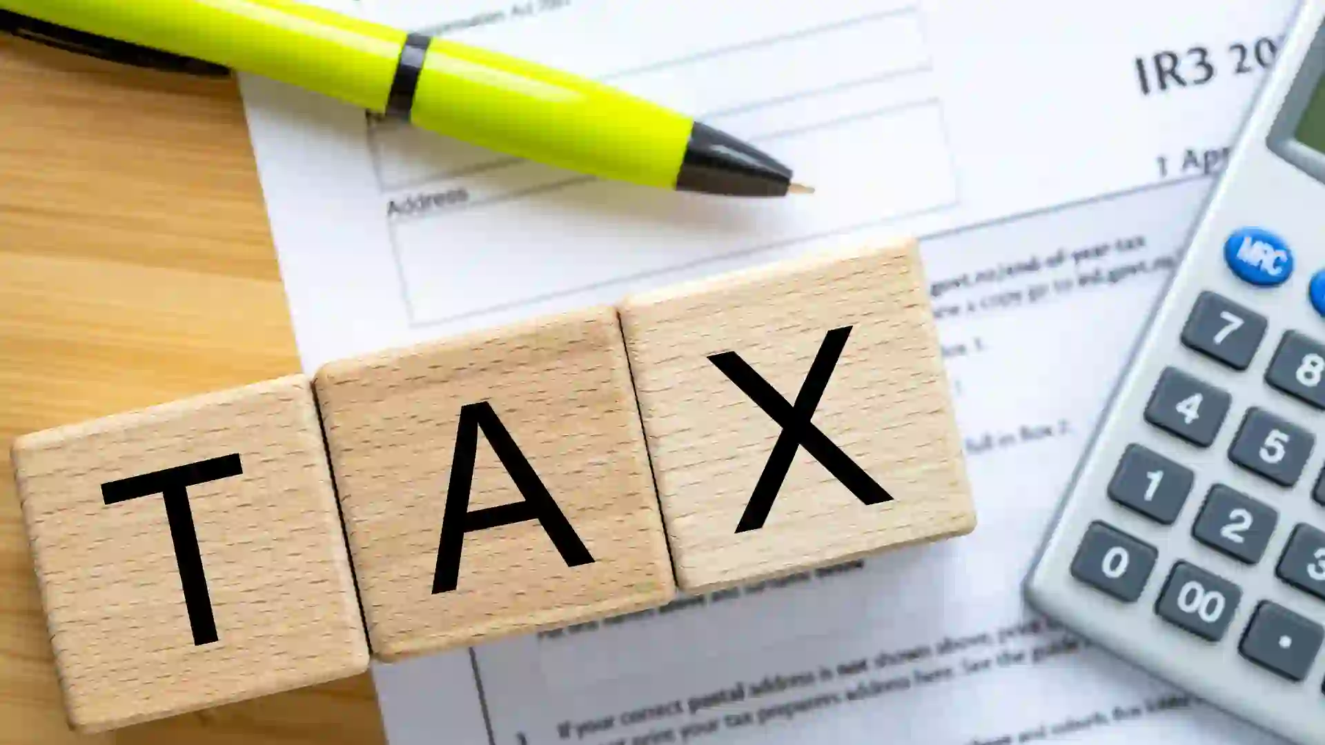 New Zealand tax return, Private form, Wooden blocks with the word Tax.