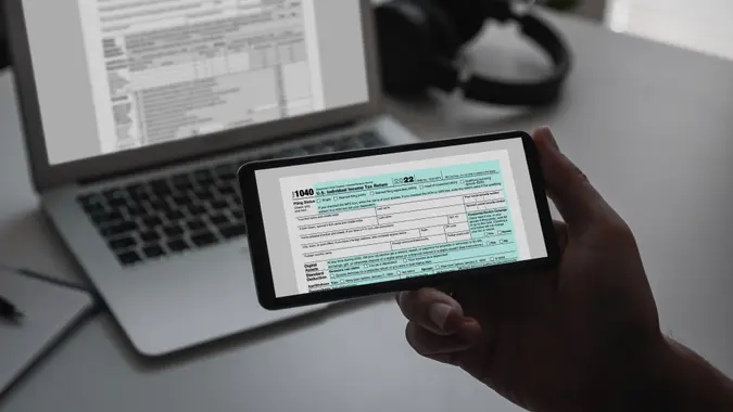 US tax form on smartphone, tax income, tax refund concept.