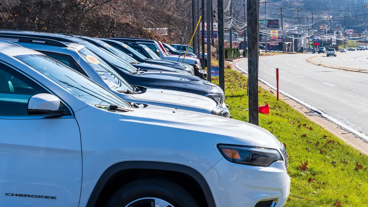A dealership in Ross Township, Pennsylvania, USA with a used cars lined up for sale stock photo