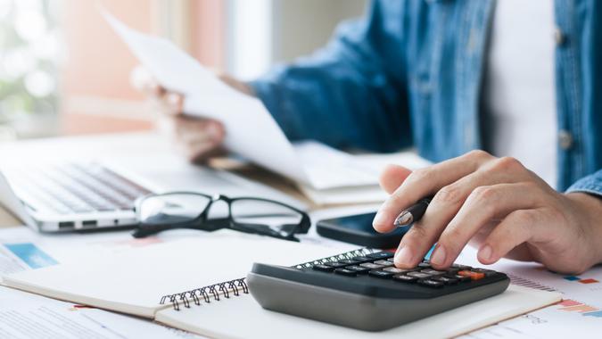 Investor using calculator